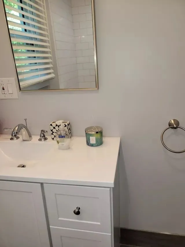 Tidy bathroom vanity and sink with a mirror reflecting a clean environment in Avon, Connecticut