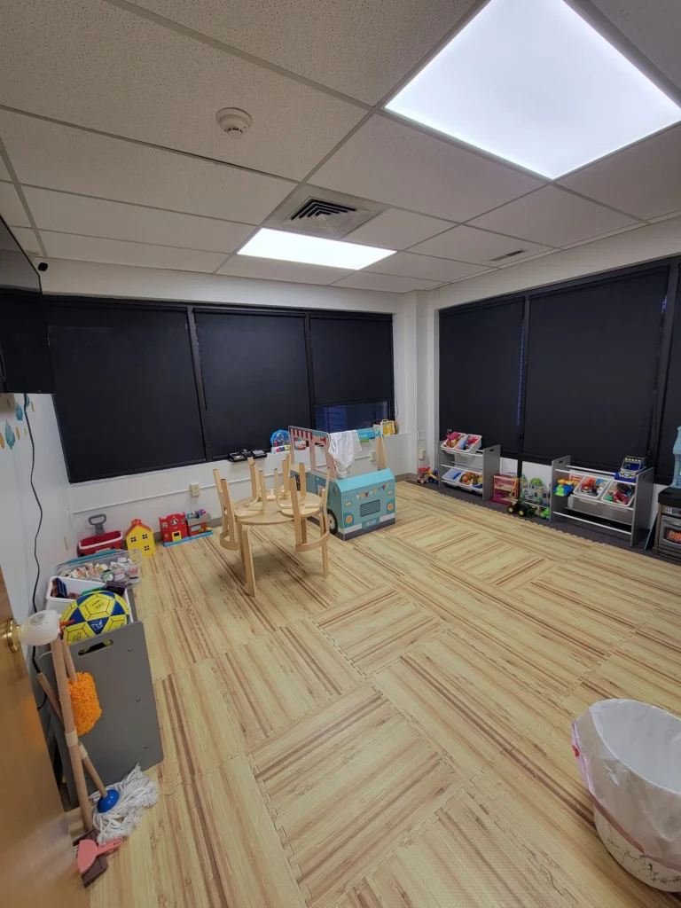 Clean and sanitized daycare room in New Britain, CT with toys neatly organized and floors freshly mopped