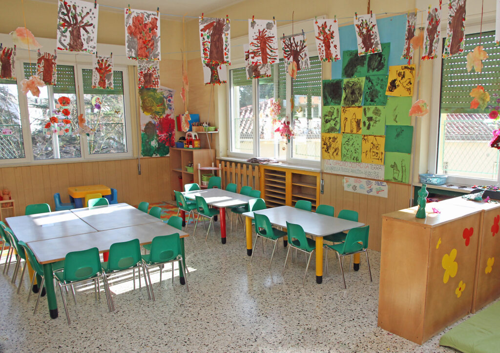 Clean daycare classroom with child-sized tables, chairs, and colorful artwork – ideal for showcasing Natassia Amazing Cleaning's daycare cleaning services in Bristol, CT