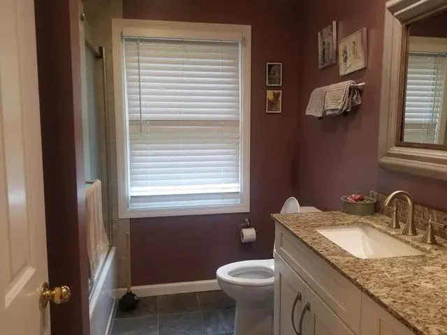 Spotless bathroom with granite countertop and tile floor after professional deep cleaning in Bristol, CT