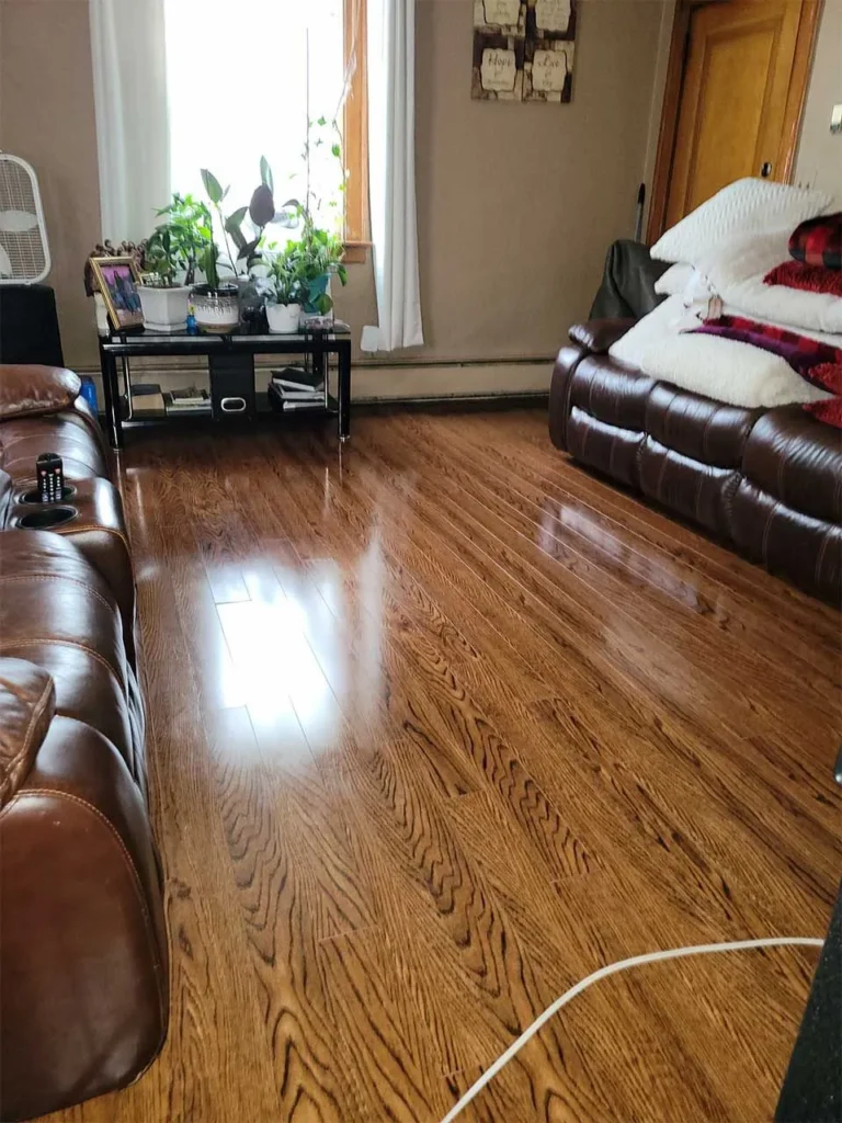 Deep cleaned living room with polished hardwood floors and leather furniture in Connecticut home