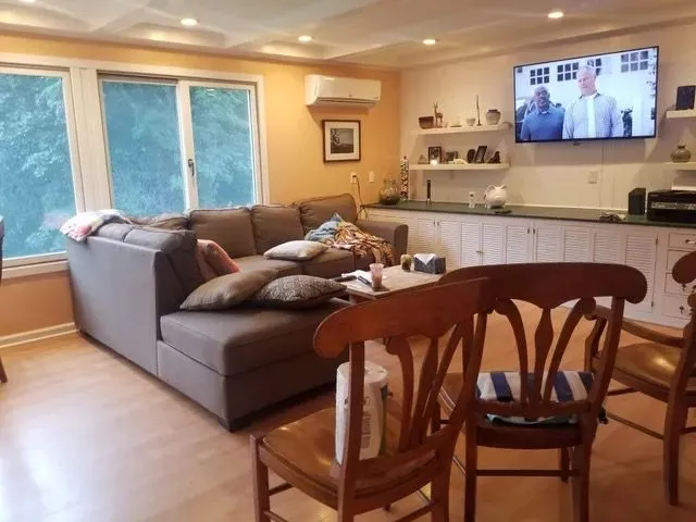 Deep cleaned family living room with sectional sofa and wood floors in Bristol, CT