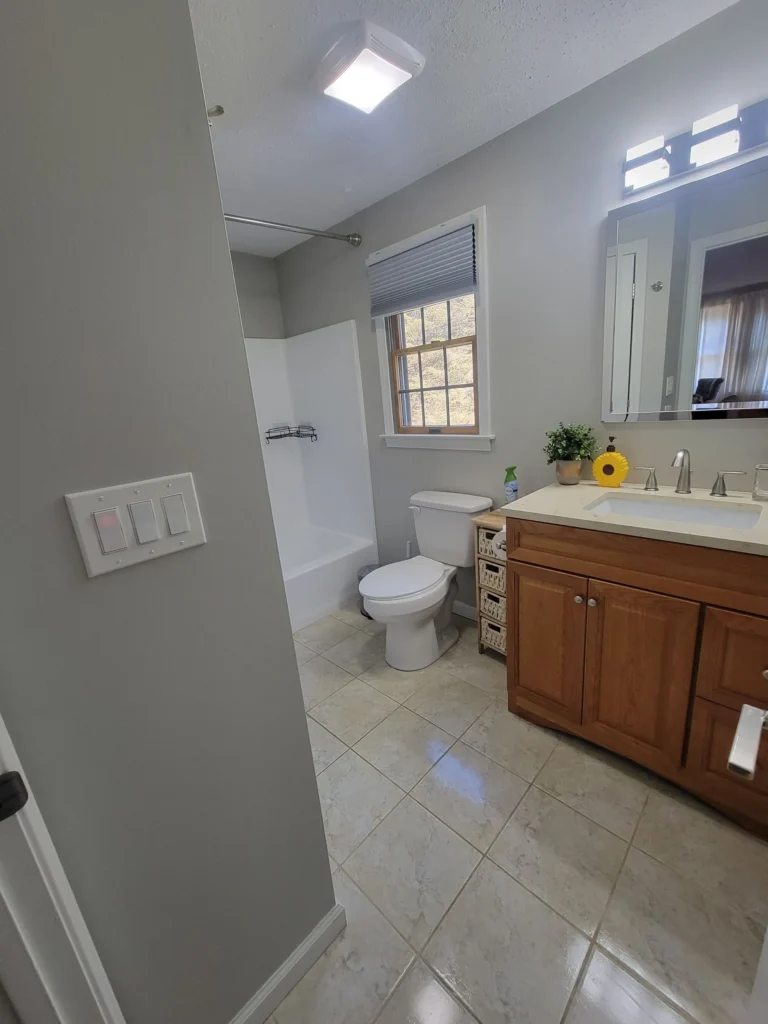 Spotless bathroom featuring a toilet, vanity, and shower area in Hartford, Connecticut
