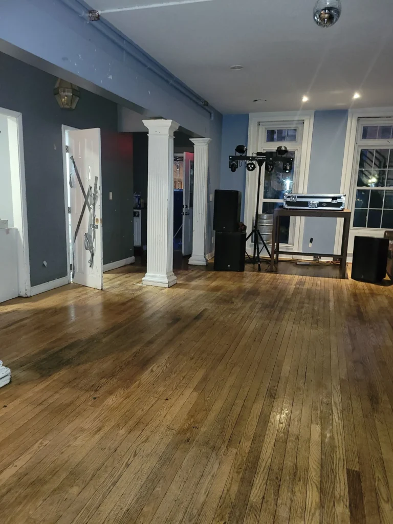 Before and after results of hardwood floor mopping and restoration in Bristol event space