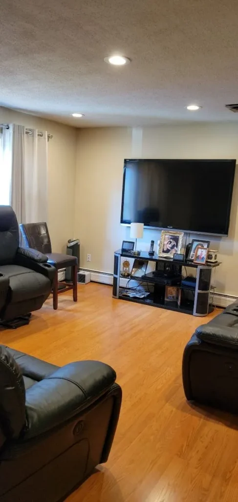 Deep cleaned living room with leather recliners and TV setup in New Britain, CT