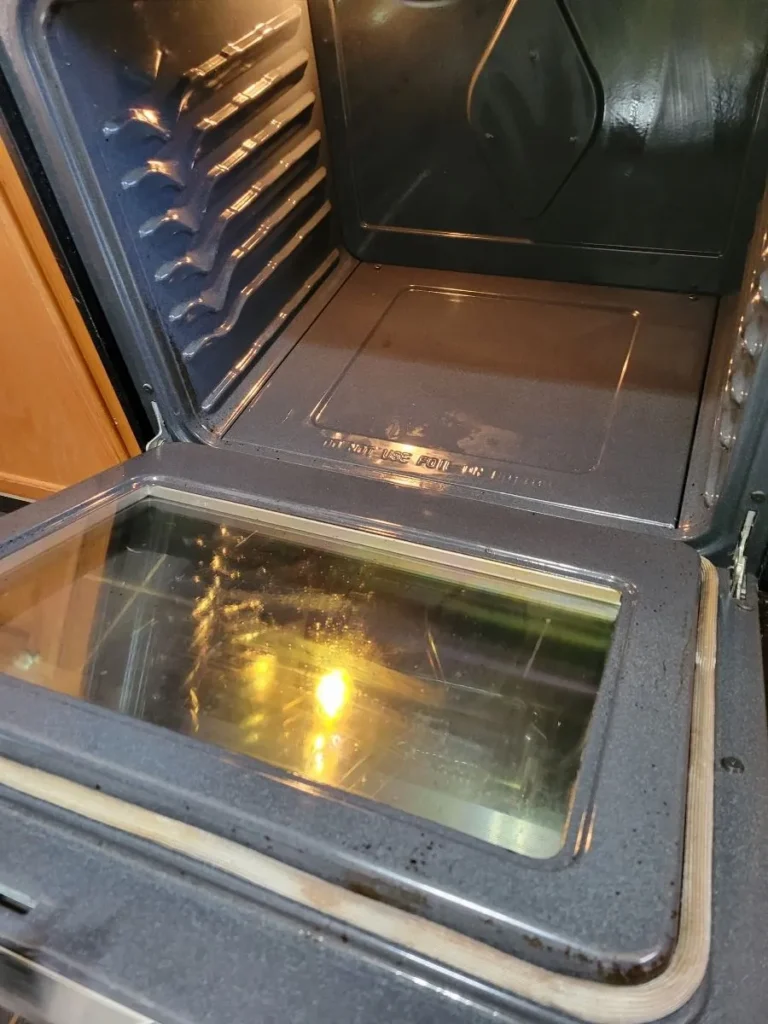 Interior of an oven with a shiny clean glass door