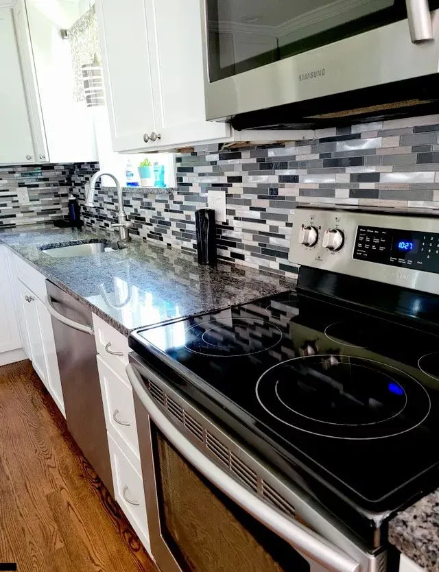 Modern kitchen in New Haven CT with clean granite countertop and backsplash