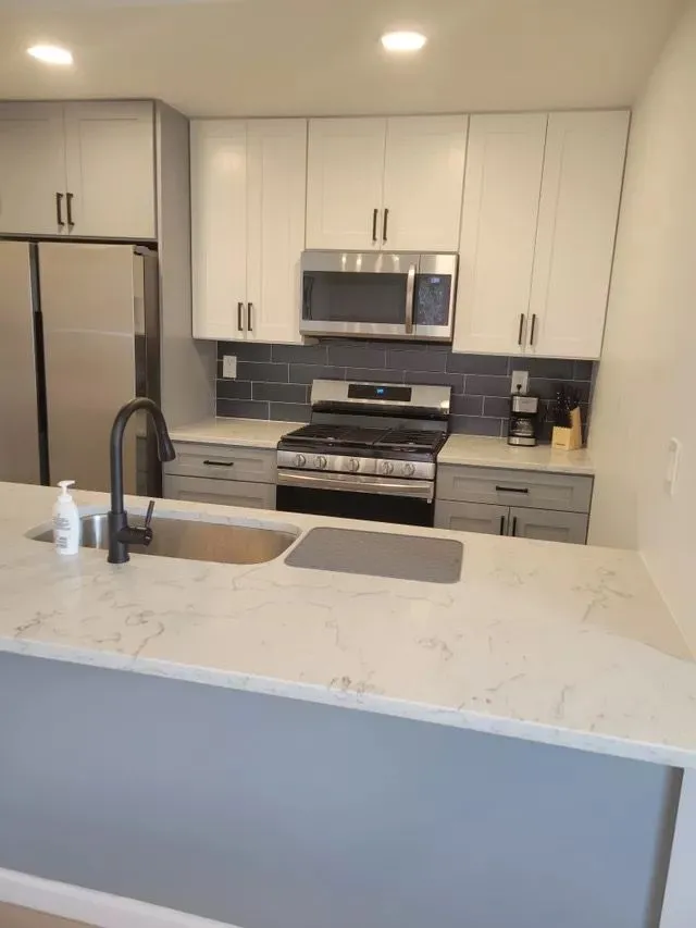 Updated Hartford kitchen with white cabinets and stainless steel appliances