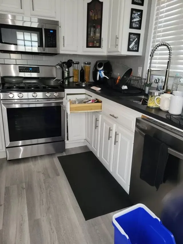 Clean modern kitchen with stainless steel appliances and white cabinets