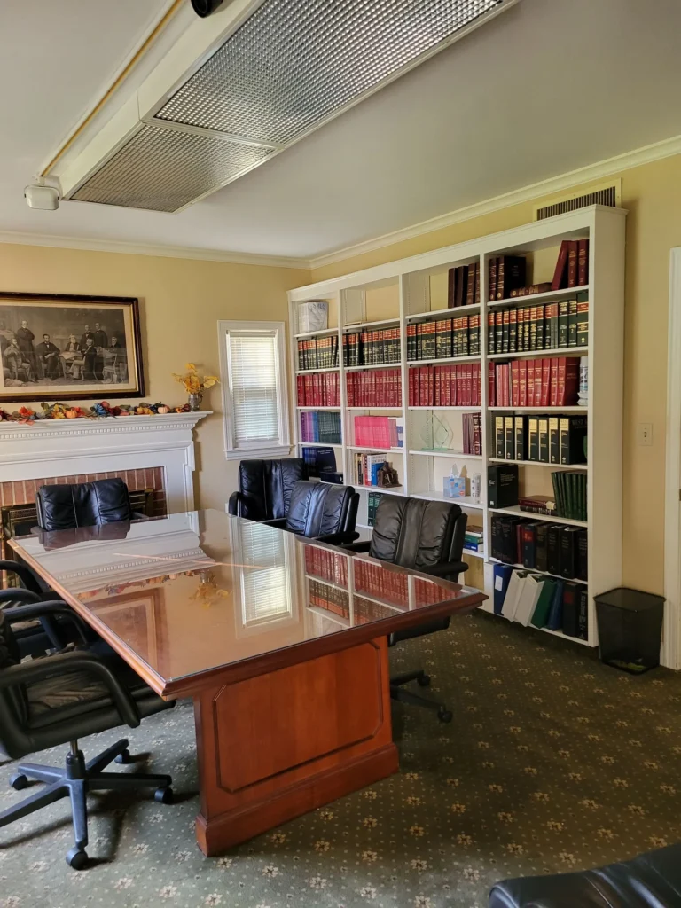 Clean boardroom with leather chairs, a polished table, and wall-to-wall bookshelves in a Connecticut office