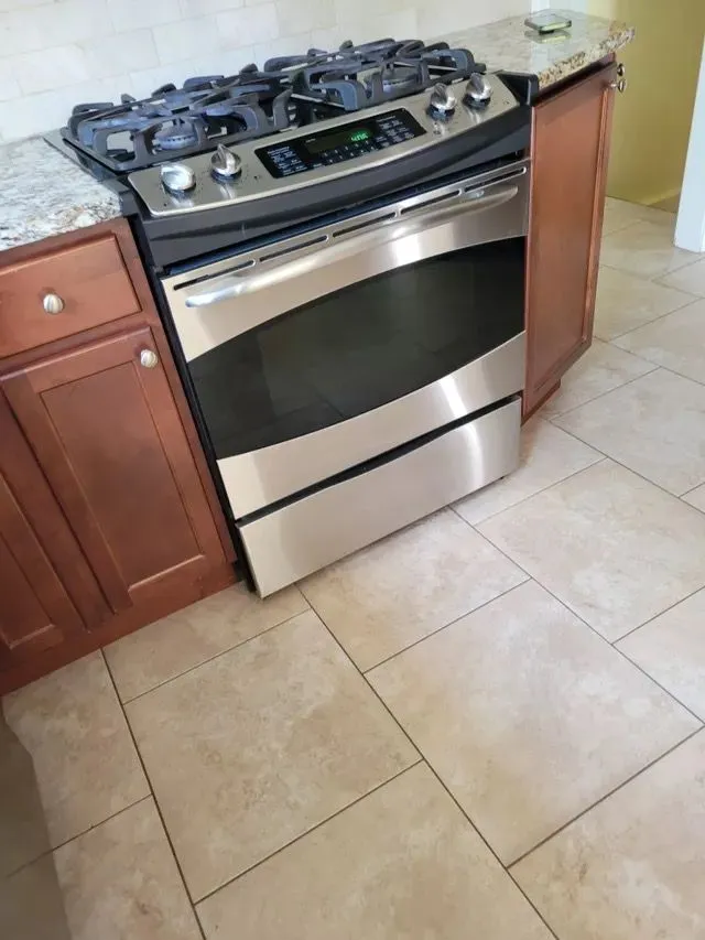 Full kitchen view with professionally cleaned oven and tile flooring in Bristol, CT