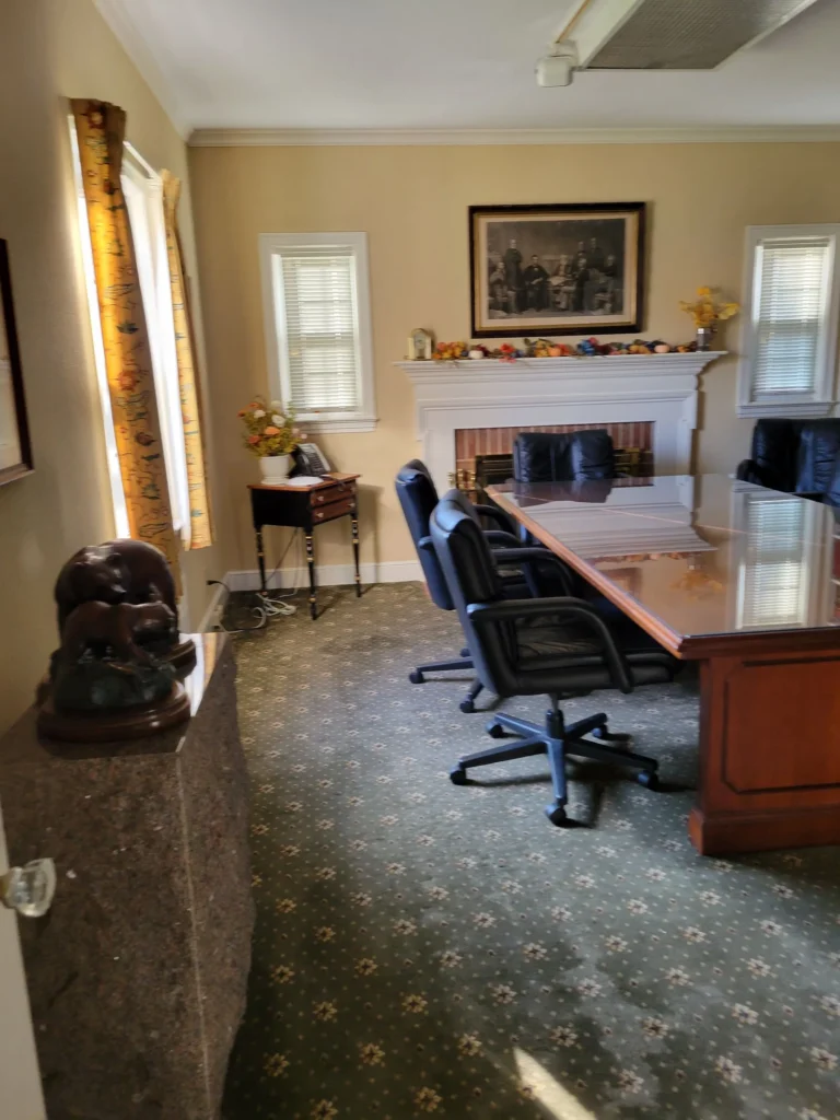 Clean office boardroom with conference table, swivel chairs, and a fireplace in Hartford County, Connecticut