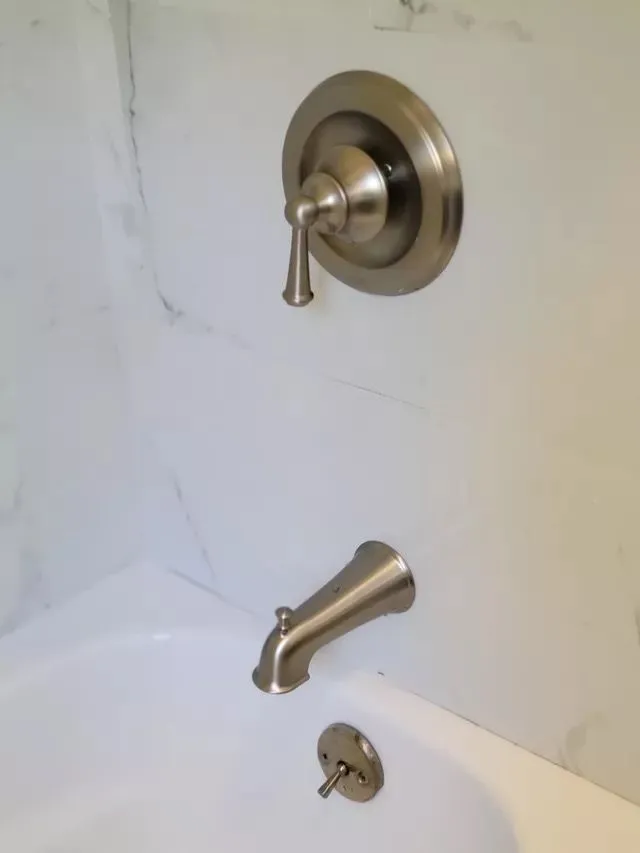 Clean brushed nickel shower fixtures in New Haven bathroom
