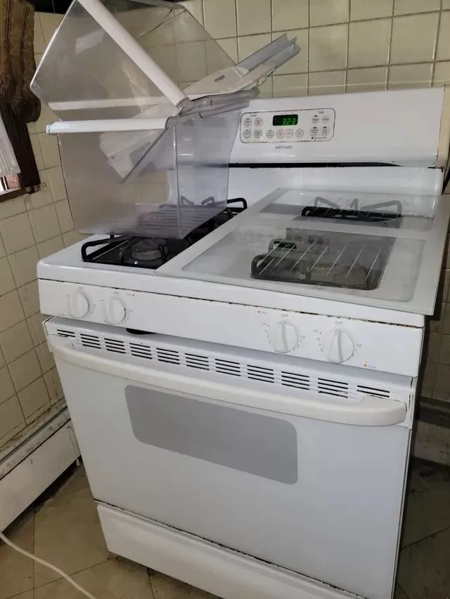 Melted plastic covering a stove before cleaning