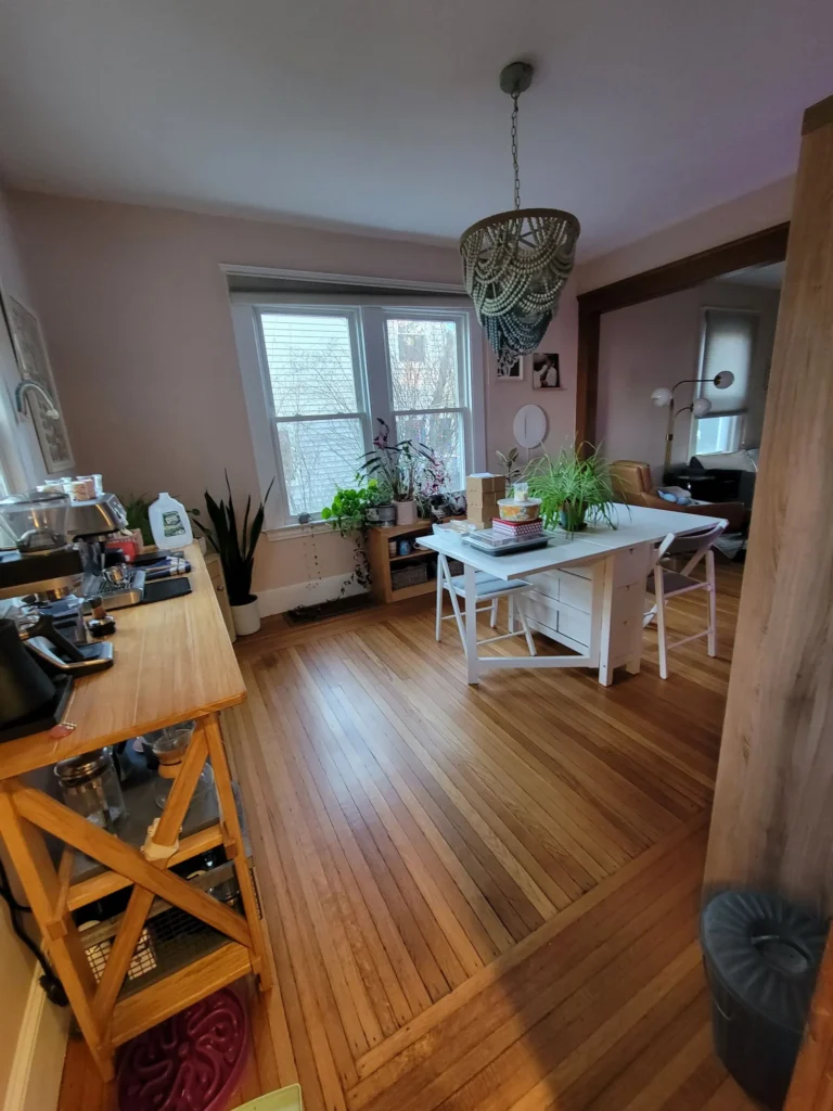 Clean wooden dining room with bright windows in Southington