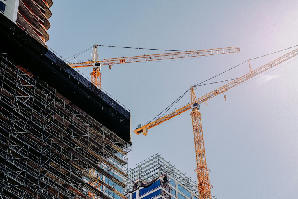 Tall building under construction with cranes
